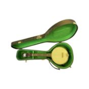 A George Formby model banjolele (ukulele banjo) in green lined hardcase.