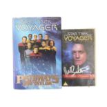 A hardback Star Trek book and VHS tape, both bearing the signature of Robert Beltran (Commander