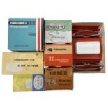 A collection of various vintage boxed stereoscopic slide viewers.