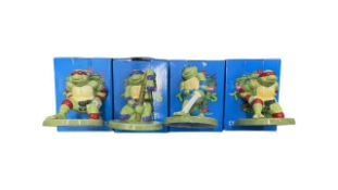 A collection of boxed ceramic Teenage Mutant Ninja Turtles figurines by Harry James