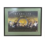 A Stargate SG-1 poster, 'The Portal to New Adventures...', bearing the signatures of several cast