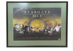 A Stargate SG-1 poster, 'The Portal to New Adventures...', bearing the signatures of several cast