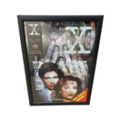 A framed and glazed magazine mock-up page, bearing the signature of X-Files creator, Chris Carter,