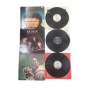 A trio of Queen 12" vinyl LPs, to include: - Greatest Hits, 1981, EMTV30 - News of the World,