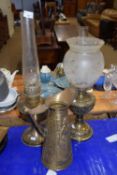 Two brass based oil lamps and a brass jug (3)