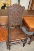 Oak hard seated hall chair with carved back panel dated 1913