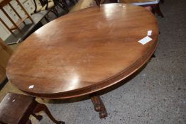 Victorian mahogany pedestal dining table with oval top raised on three scroll legs