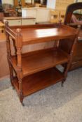Mahogany three tier buffet cabinet with turned supports and brass and ceramic casters, 90cm wide