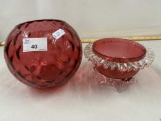 Cranberry glass bowl with frilled rim together with a further globe formed vase