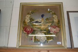 A needlework study, a pair of ducks amongst flowers, framed and glazed