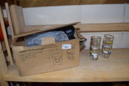 Boxed security light and a quantity of small shot glasses decorated with cars