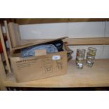 Boxed security light and a quantity of small shot glasses decorated with cars