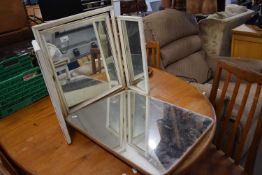 Cream and gilt framed tri-fold dressing table mirror together with a wall mirror