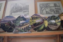 Four Royal Doulton plates decorated with trains