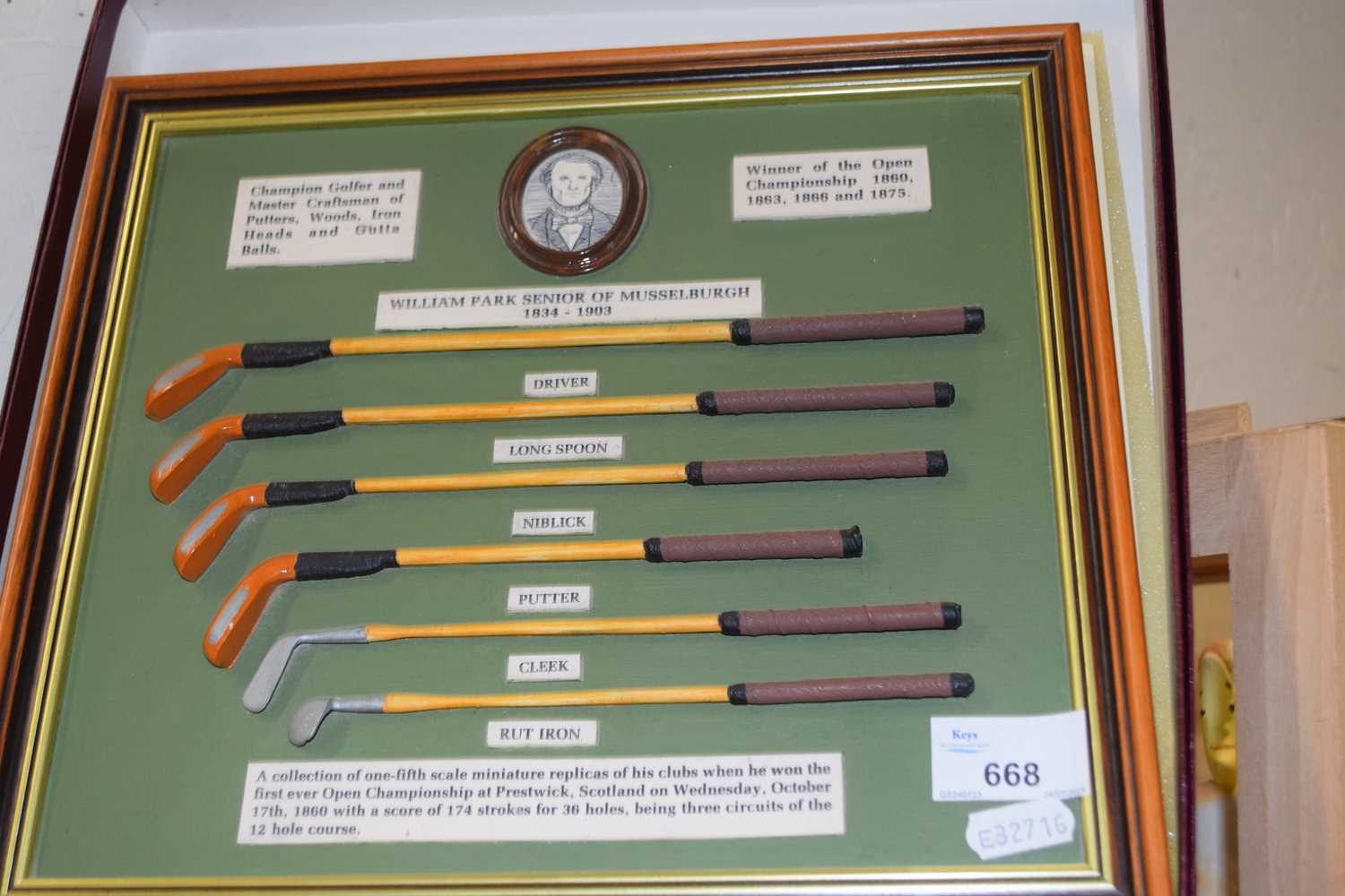 A framed display of miniature golf clubs