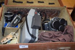 A case containing a Polaroid camera, a Yashica Cine Camera and other accessories