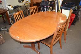 An oval twin pedestal extending dining table with four matching chairs, G plan.