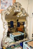 A silver painted decorative wall mirror
