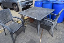Square metal garden table together with four stacking chairs