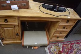 Twin pedestal pine desk with four drawers to one side and cupboard and single drawer to the other,
