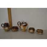 Collection of Doulton stone ware condiment pots and small jugs