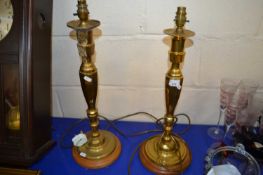 Pair of brass and wooden based table lamps