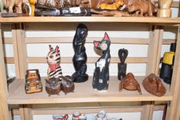 Quantity of African carvings together with a pair of carved wooden owls and others