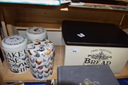 Three Emma Bridgewater storage tins together with a ceramic bread bin