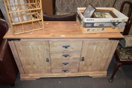 A pine sideboard with cupboards to either side and drawers to centre, approx 130cm wide