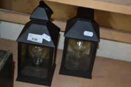 Two battery operated storm lanterns