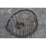 A cast iron wall mounted hay basket and shoe last (2)