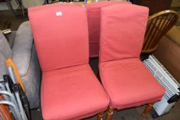 Four pine dining chairs with pink slip covers