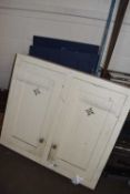 A cream painted pine wall cupboard and wooden doors