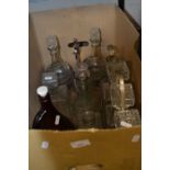 A three bottle tantalus together with quantity of assorted decanters