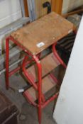 A red metamorphic step stool