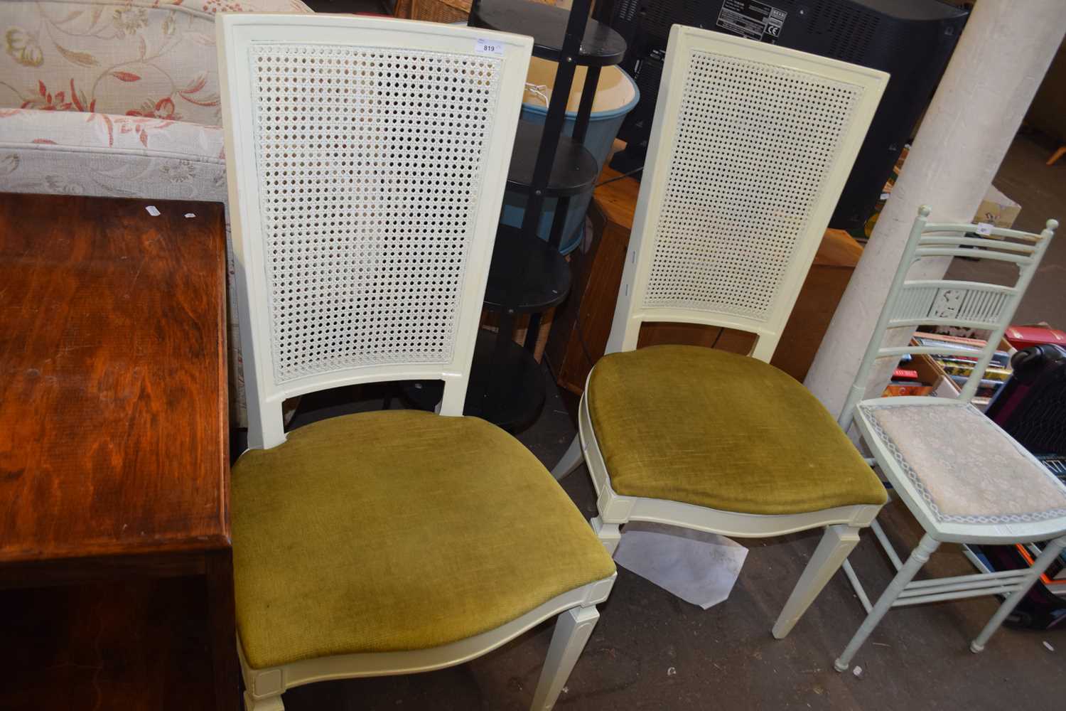 Two cream painted dining chairs with green velour seats