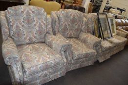 Three piece suite comprising three seater sofa and two matching armchairs
