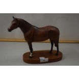 A Beswick model of a thoroughbred racehorse on plinth base