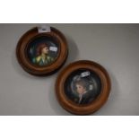 A pair of small painted saucers mounted in hardwood frames