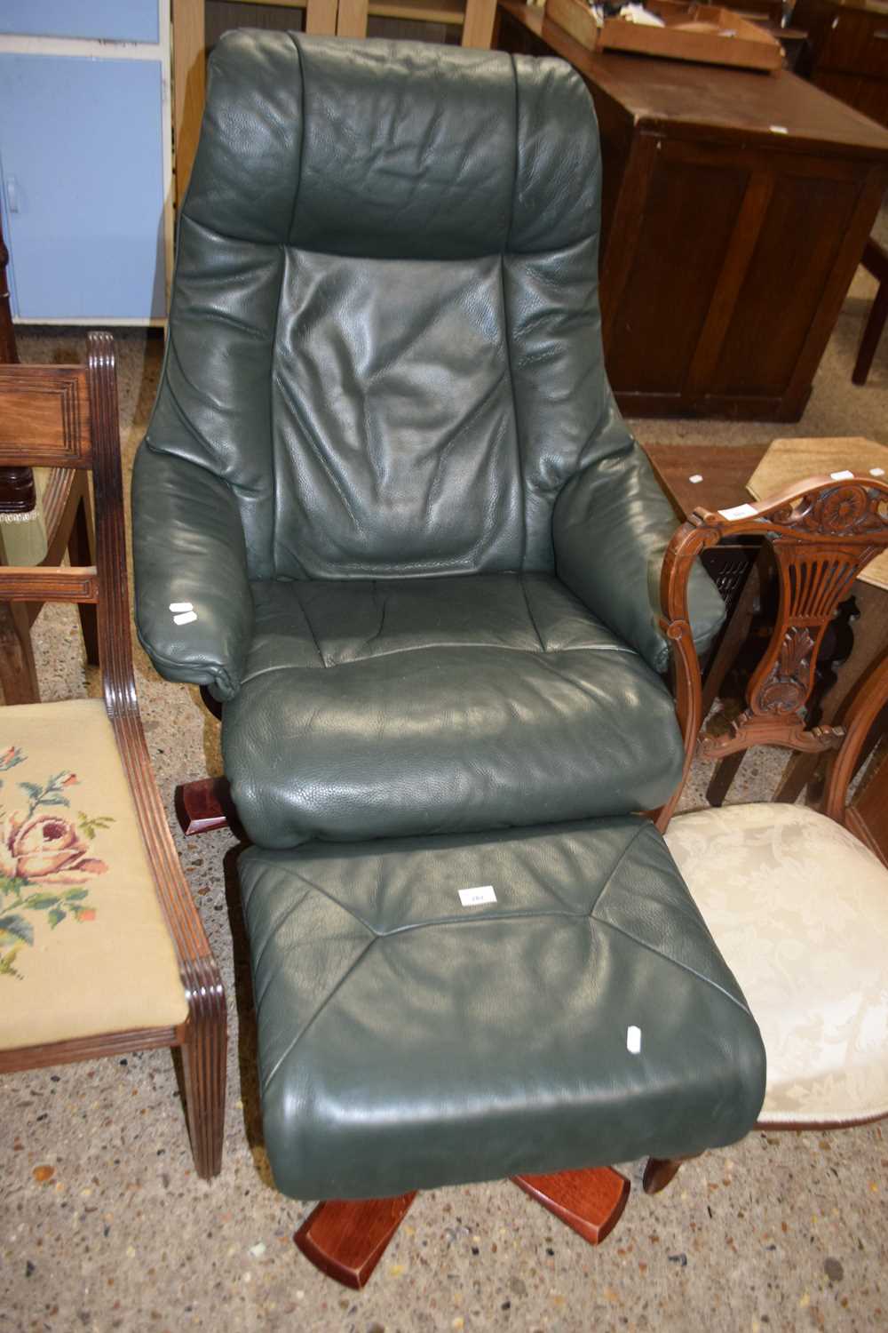 Green leather upholstered recliner chair and stool