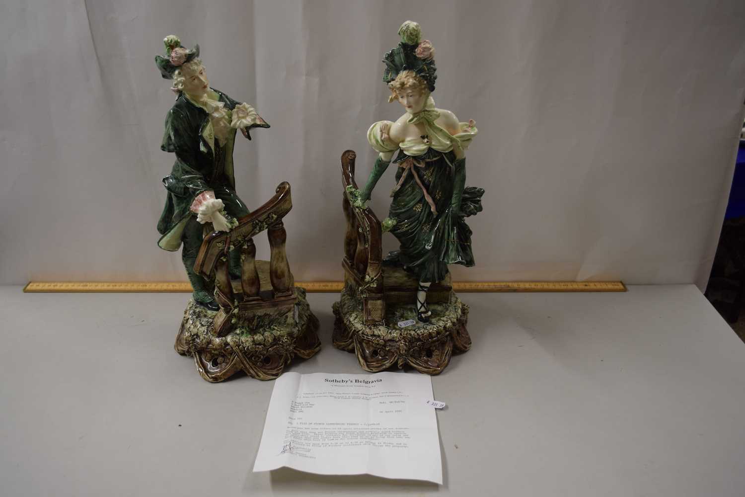 A pair of early 20th Century French earthenware figures mounted on plinth bases together with a