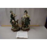 A pair of early 20th Century French earthenware figures mounted on plinth bases together with a