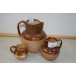 Two Royal Doulton stone ware harvest type jugs and a similar condiment pot (3)