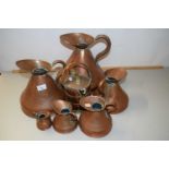 A graduated set of copper haystack measuring jugs plus one other (8)