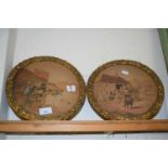 A pair of circular framed studies, village scenes with horses and carts