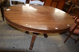 Victorian mahogany pedestal dining table with oval top raised on three scroll legs