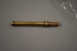 A small yellow metal mounted manicure tool marked S. Mordan