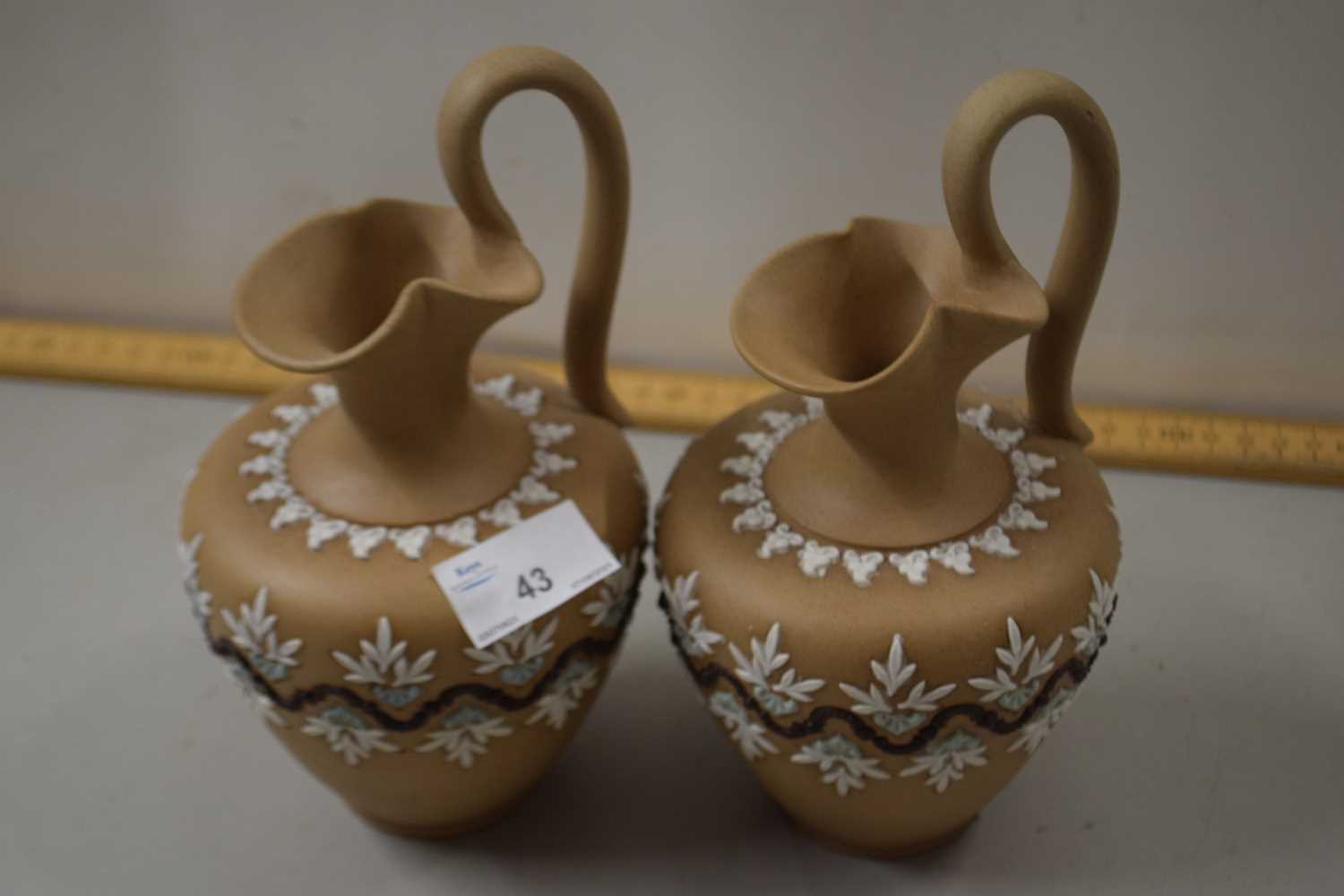 A pair of Doulton Lambeth silicon ware jugs