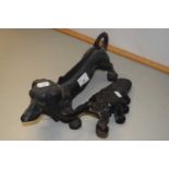 A Dachshund shape cast iron boot scraper and a further boot jack (2)