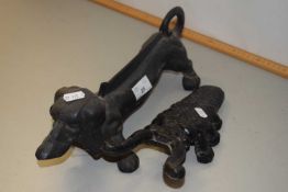 A Dachshund shape cast iron boot scraper and a further boot jack (2)